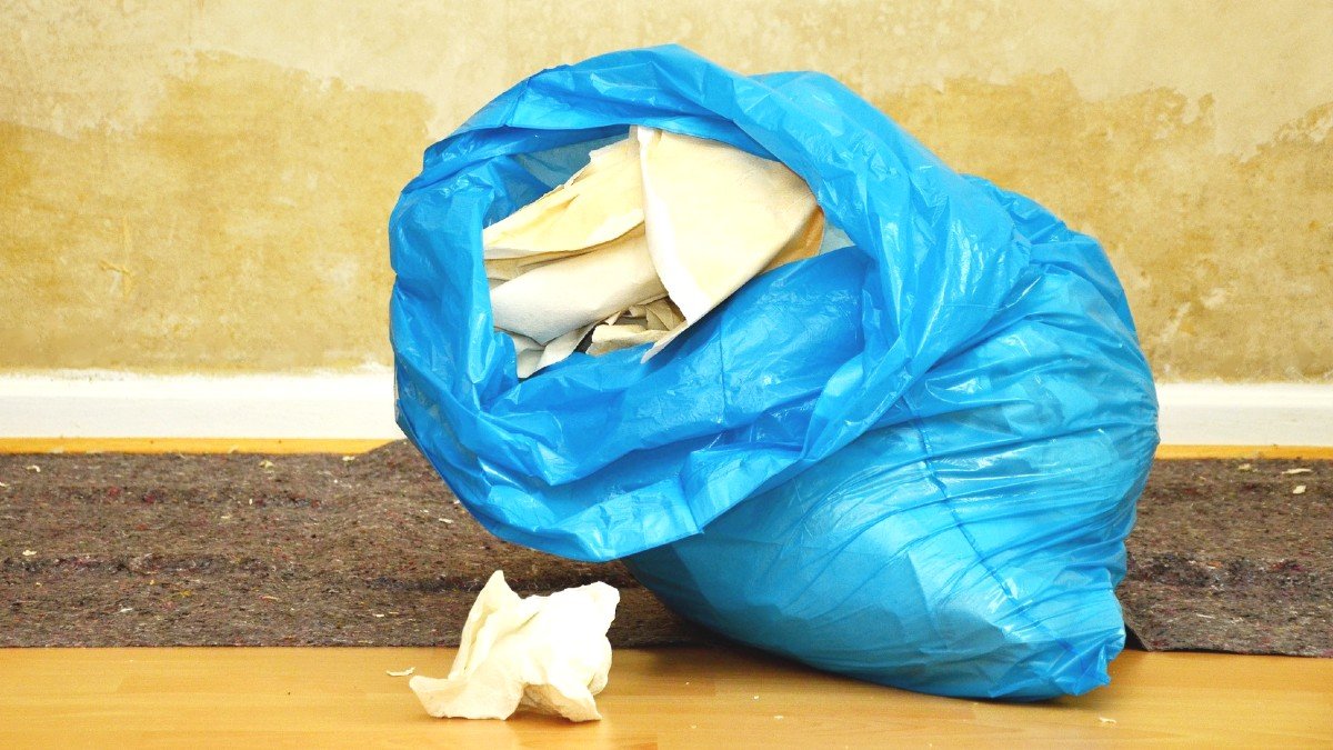 a blue garbage bag sitting on the floor