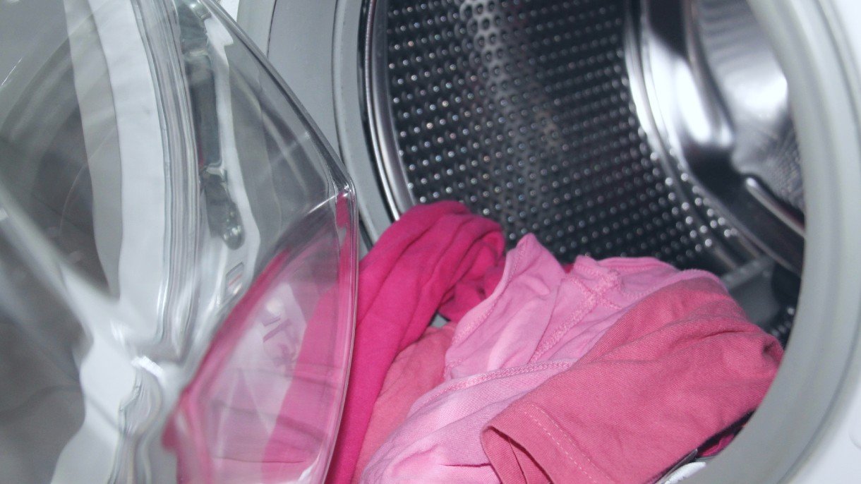 pink clothing in waching machine with the doors open