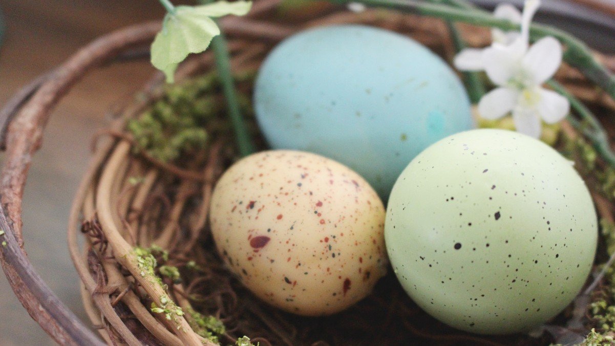 colorful eggs in a woven basket